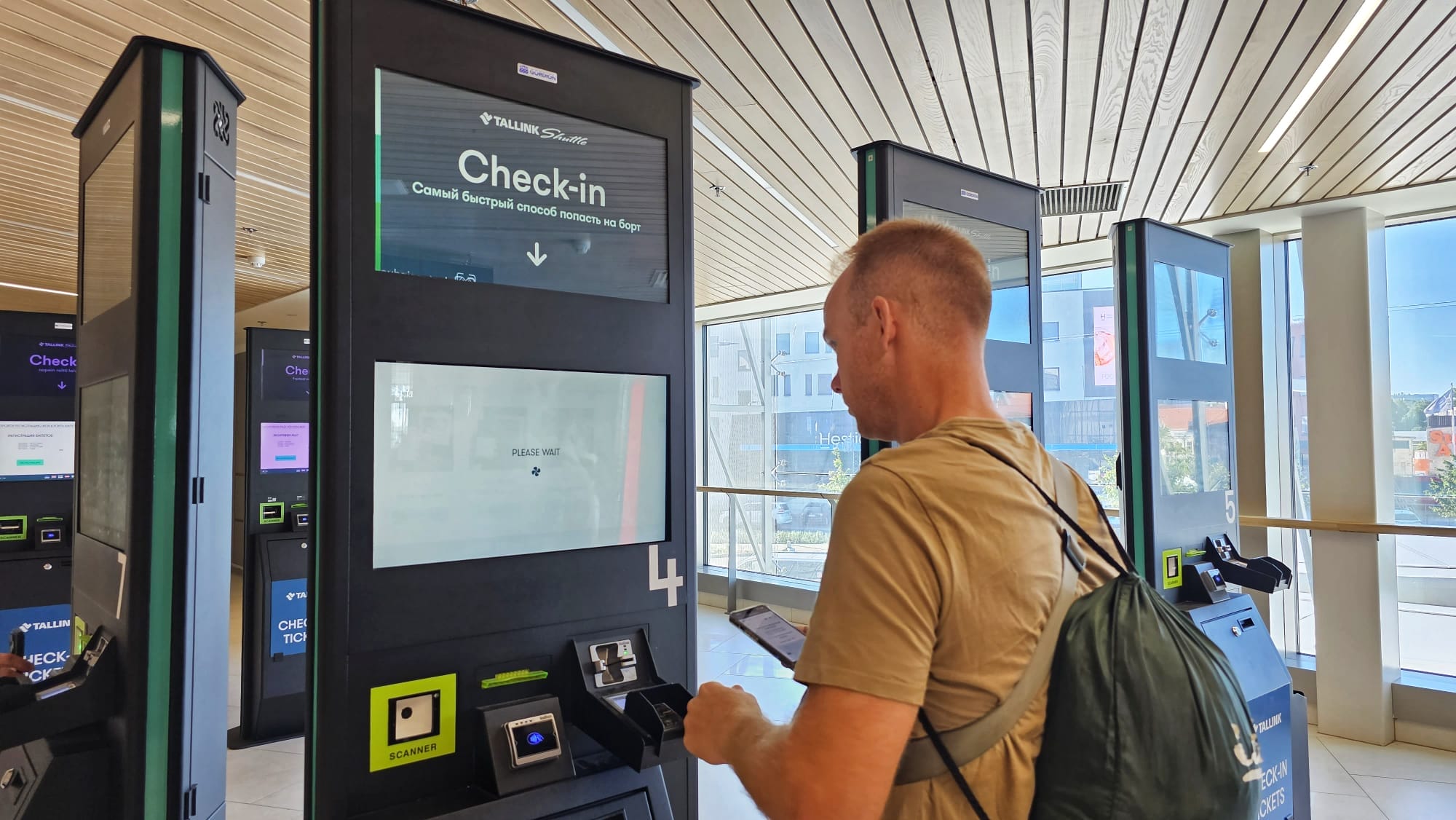 A man checking in at an automated kiosk at the ferry port in Tallinn, Estonia.