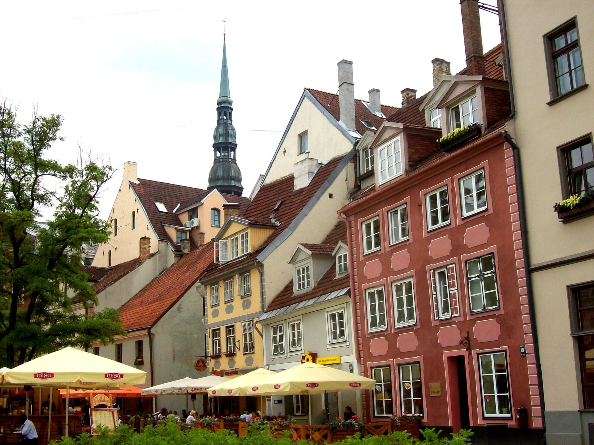 Colorful historic buildings and outdoor cafes in the old town of Riga, Latvia.